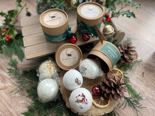 Natural, handmade bath bomb in Christmas themed kraft tube with ribbon, tag and bauble.