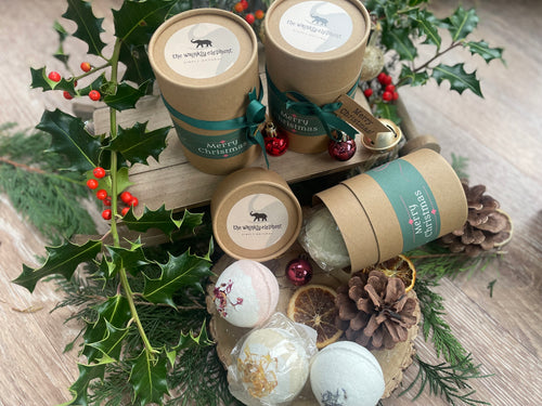 2 natural bath bombs in a kraft tube with Christmas ribbon ,tag and bauble.
