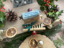 Christmas handcrafted natural soap bar and ladder, wrapped in ribbon with a Christmas tag and bauble.