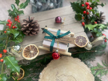 Christmas handcrafted natural soap bar and ladder, wrapped in ribbon with a Christmas tag and bauble.