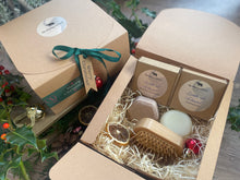 A Christmas set including natural solid shampoo and conditioner bar along with a bamboo brush 