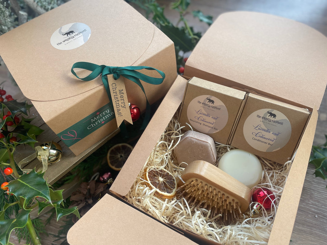 A Christmas set including natural solid shampoo and conditioner bar along with a bamboo brush 