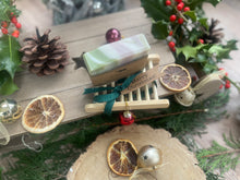Christmas handcrafted natural soap bar and ladder, wrapped in ribbon with a Christmas tag and bauble.