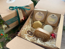 A Christmas set including natural solid shampoo and conditioner bar along with a bamboo brush 