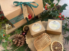 A Christmas set including natural solid shampoo and conditioner bar along with a bamboo brush 