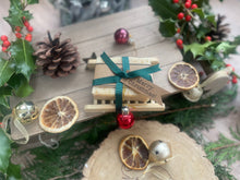 Christmas handcrafted natural soap bar and ladder, wrapped in ribbon with a Christmas tag and bauble.