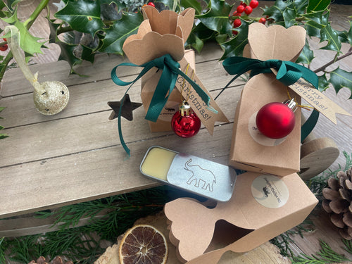 Natural handmade lip balm in a Christmas themed kraft cracker.