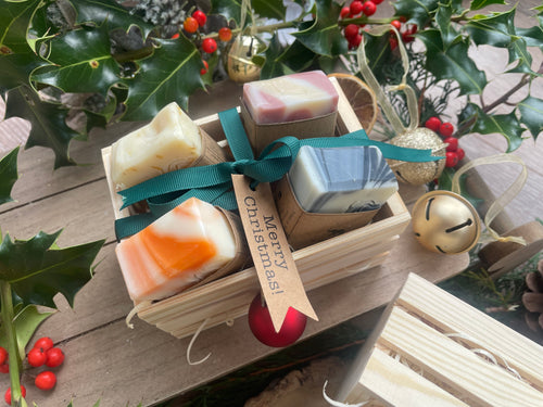 Beautiful box of natural, handmade mini soap bars with ribbon and a 'Merry Christmas!' tag, 