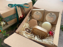 A Christmas set including natural solid shampoo and conditioner bar along with a bamboo brush 