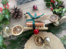 Christmas handcrafted natural soap bar and ladder, wrapped in ribbon with a Christmas tag and bauble.