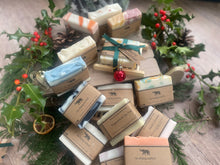 Christmas handcrafted natural soap bar and ladder, wrapped in ribbon with a Christmas tag and bauble.
