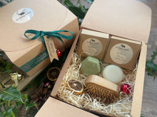 A Christmas set including natural solid shampoo and conditioner bar along with a bamboo brush 