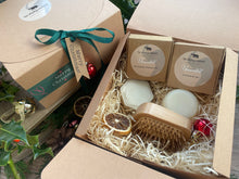 A Christmas set including natural solid shampoo and conditioner bar along with a bamboo brush 