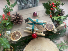 Christmas handcrafted natural soap bar and ladder, wrapped in ribbon with a Christmas tag and bauble.